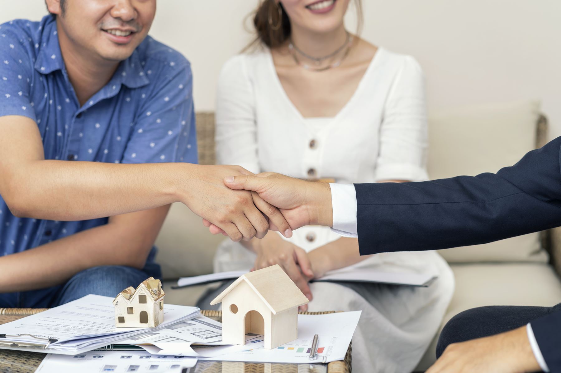 Loan officer shaking hands with couple